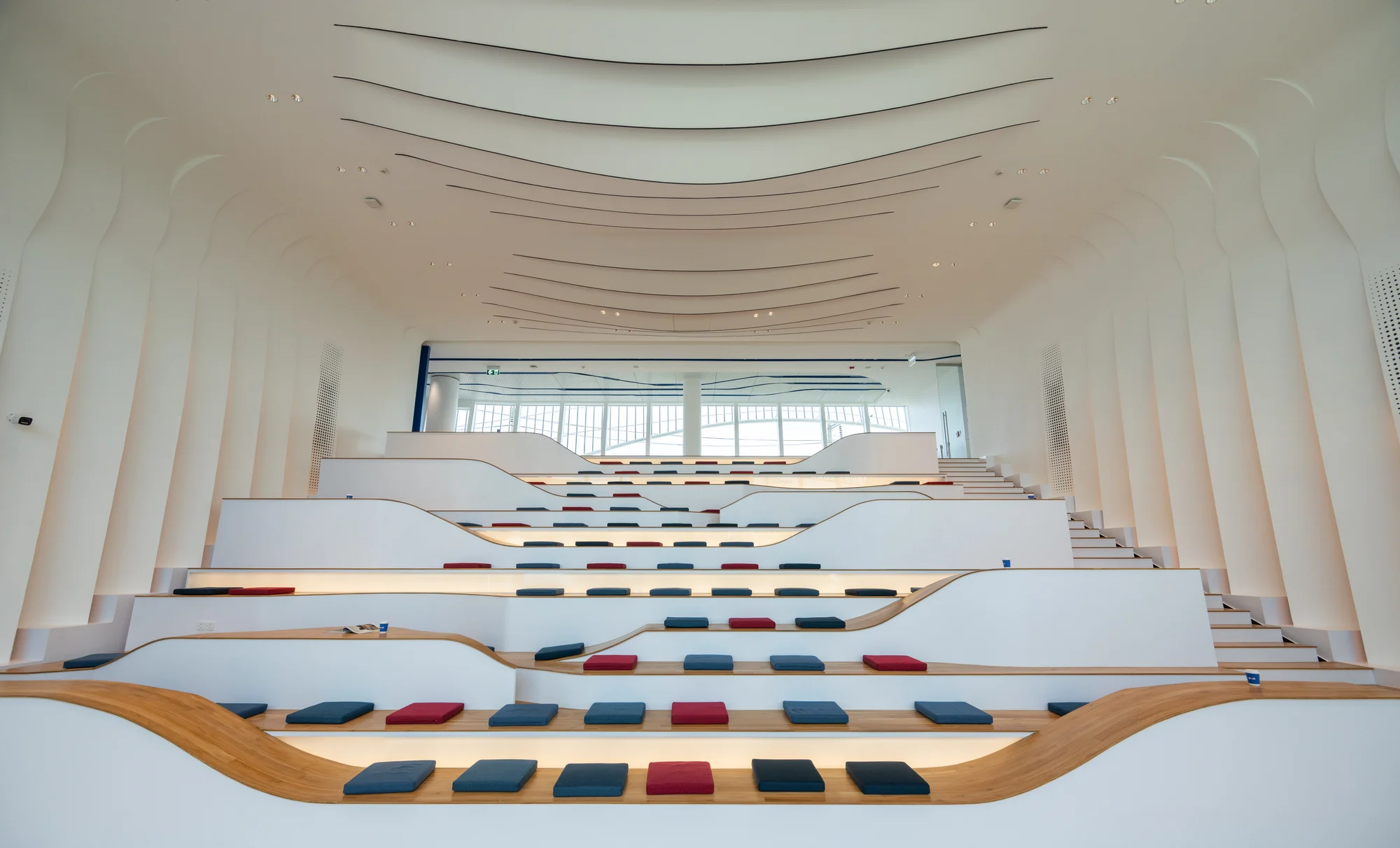 Tiered seating and curved ceiling inside the campus auditorium